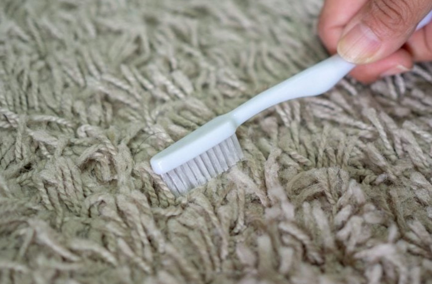 Use a toothbrush - How to Remove Lint From Clothes